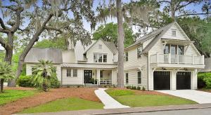 a white house with a porch and a driveway at 4 Bedroom Wilson Village Home 25 in Bluffton