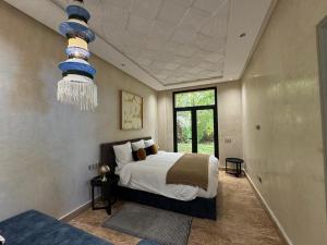 a bedroom with a bed and a chandelier at Villa Ania in Marrakesh +56 photos