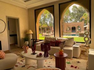 a living room with a couch and a large window at Villa Ania in Marrakesh