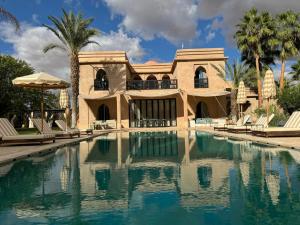 a large house with a swimming pool in front of it at Villa Ania in Marrakesh
