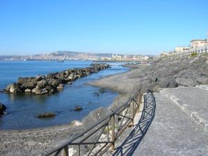 a bridge over a body of water with rocks at Gold House in Naples