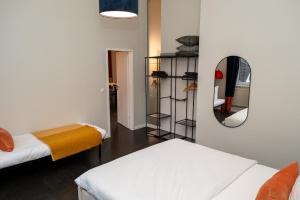 a room with two beds and a mirror at 135qm Loft vor den Toren Hamburgs in Schenefeld