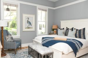 a bedroom with a large bed with a bird picture on the wall at 3 Bedroom Wilson Village Home 23 in Bluffton +62 photos
