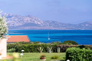 a view of the ocean from a house at Cala Rosa Club Hotel in Stintino