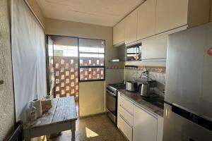 a small kitchen with a stove and a refrigerator at Buena Vista in Paysandú