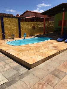a swimming pool in the middle of a patio at Casa da Santa in Coruripe