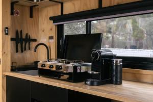 a kitchen counter with a stove and a microwave at Heyscape Denmark in Denmark