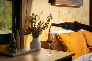 a glass of wine on a table with a vase at Heyscape Denmark in Denmark