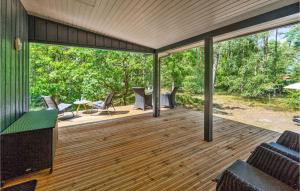 a screened in porch with chairs and a table at 3 Bedroom Gorgeous Home In Nexø in Neksø +14 photos