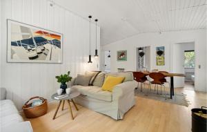 a white living room with a couch and a table at 3 Bedroom Gorgeous Home In Nexø in Neksø
