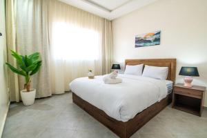 a bedroom with a large bed with a stuffed animal on it at Central Agadir, Modern and Convenient in Agadir