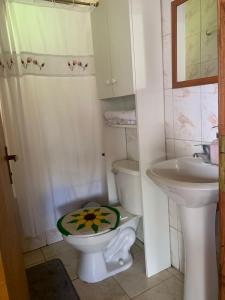 a small bathroom with a toilet and a sink at Cabañas Doña Norma in Puyehue