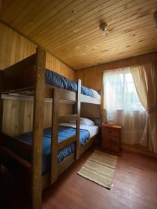 a bedroom with two bunk beds in a cabin at Cabañas Doña Norma in Puyehue +7 photos