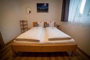 Postel nebo postele na pokoji v ubytování Haus Bazigg