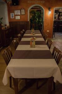 a dining room with a long table and chairs at Gostinstvo Tomex in Ilirska Bistrica