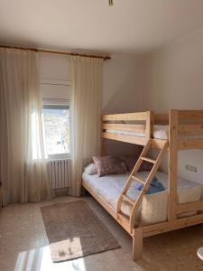 a bedroom with two bunk beds and a window at Casa Rural Can Bastida in Cardona