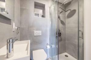 a bathroom with a shower with a toilet and a sink at Modern 2 Bed Oasis - Private parking & Garden in Windsor +17 photos