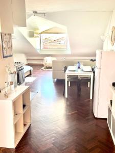 a kitchen and living room with a table and a refrigerator at Cozy Carcavelos Beach-NOVA SBE in Carcavelos