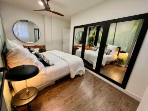 a bedroom with a large bed and a mirror at BILBAO NORTH SHORE APARTMENTS in Bilbao