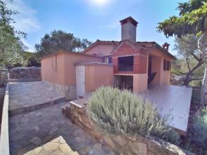 a house with a stone walkway in front of it at House Nature park in Sali +11 photos