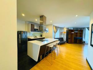 a kitchen with a white counter top and a black refrigerator at Continental Aparthotel Bogotá - Aparta Suite in Bogotá