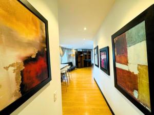 a hallway with a bunch of art on the walls at Continental Aparthotel Bogotá - Aparta Suite in Bogotá +264 photos