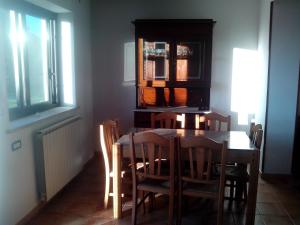 a dining room with a wooden table and chairs at Villa Oasi in Gaeta