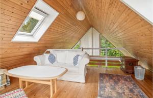 a living room with a white couch and a table at Lovely Home In Samsø With Wifi in Tanderup +9 photos