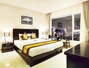 A bed or beds in a room at D&C Hotel