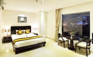 A bed or beds in a room at D&C Hotel