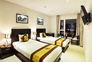 A bed or beds in a room at D&C Hotel