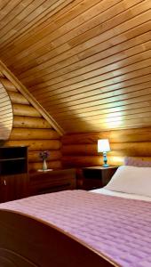 a bedroom with a bed and a wooden ceiling at Cottage Karinka in Bukovel +71 photos