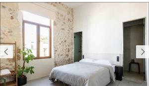 a bedroom with a large bed and a window at Holidays in Chania Hotel in Chania