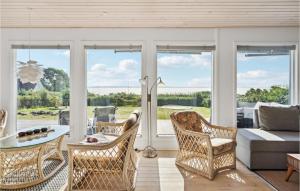 a living room with wicker chairs and a couch at Awesome Home In Ebberup With Kitchen in Ebberup