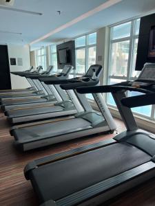 a row of treadmills in a gym with windows at Brisas do Lago em Brasília in Brasilia