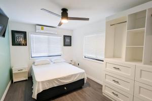 una camera da letto con letto, armadi bianchi e soffitto di Elenas Modern 2BR Comfy Home a San Ignacio