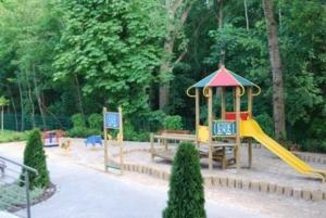 a playground with a slide in a park at Wyspa Uznam - Apartamenty Zdrojowa in Świnoujście