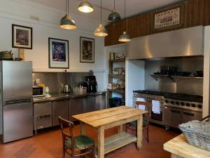 a kitchen with a wooden table and a kitchen with a stove at Preston House in Abbeyleix