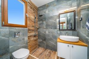 a bathroom with a sink and a mirror at Villa Drogarati Retreat by Villa Plus in Chaliotata +14 photos