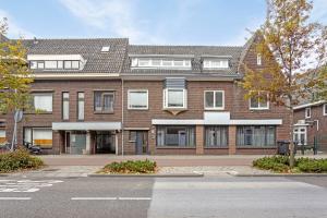 a large brick building with windows on a street at Hertog 2 in Eindhoven