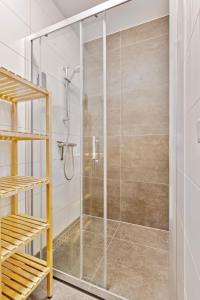 a shower with a glass door in a bathroom at Hertog 2 in Eindhoven +18 photos