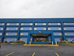 un edificio azul con un estacionamiento delante de él en Baymont by Wyndham Davenport, en Davenport