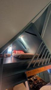 a bunk bed in a room with a staircase at La Nuée Bleue in Strasbourg