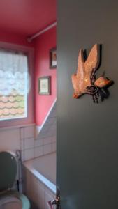 a bathroom with a toy fish on the wall at La Nuée Bleue in Strasbourg