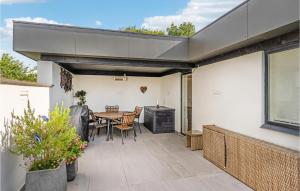 a patio with a table and chairs on it at 3 Bedroom Lovely Home In Børkop in Børkop