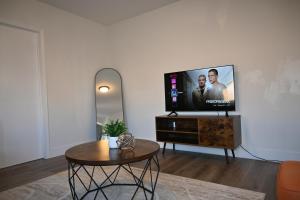 a living room with a flat screen tv on a table at Downtown Hartford 2BR Family Pet Friendly in Hartford