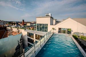 a swimming pool on the roof of a building at Sarah's Home with POOL, WELLNESS, FITNESS in Budapest