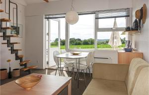 a living room and kitchen with a table and chairs at Nice Apartment In Allinge in Allinge