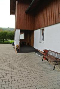 a bench sitting in front of a building at Pension Jitka in Šimonovice