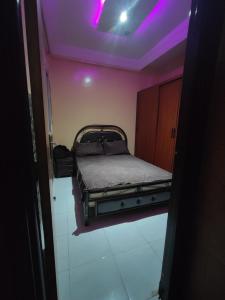 a bed in a room with a purple ceiling at zone 44 Massira 3 in Marrakech
